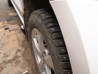 Wheel replacement. Seasonal tire replacement before snowfall. Part of the photo is blurred.