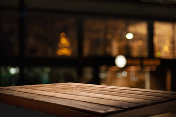 empty table to showcase your product, against the background of a blurred cafe golden bokeh