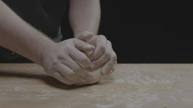 Kneading dough against a table as we push in