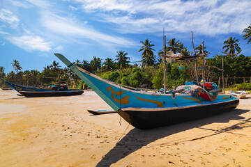 Fototapeta na wymiar Traditional fishing boats on a sandy beach. Sri Lanka