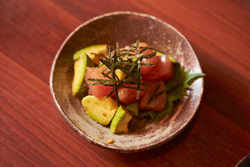 Avocado salmon with sauce and seaweed 