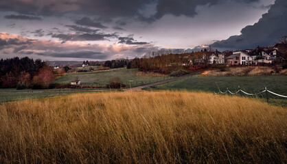 Red, sunset sky, view of the village, autumn.