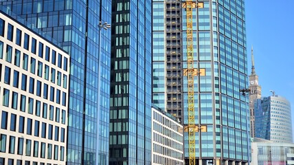 View of a skyscraper under construction. Modern architecture background. Building a high-rise building,  the concept of real estate construction. 