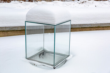 Large glass transparent cube as an element of garden or courtyard decoration