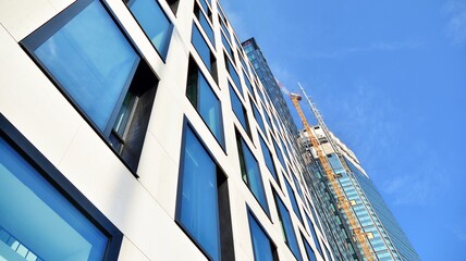 Fototapeta premium View of a skyscraper under construction. Modern architecture background. Building a high-rise building, the concept of real estate construction. 