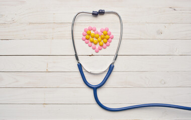 Scraping on the table and heart from pills wooden background texture health vitamins