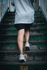 Fototapeta na wymiar Hiit workout cardio running jogging up the stairs training. Staircase climbing run woman going run up steps. Runner athlete doing cardio sport workout.