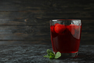 Glass of strawberry jelly on black smokey table