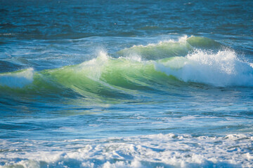 Fototapeta premium Stormy Pacific ocean, beautiful waves in turquoise color close up. Water surface, copy space