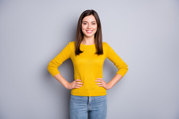 Photo of young attractive happy smiling cheerful lovely girl wear yellow sweater and jean isolated on grey color background