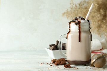 Concept of delicious food with chocolate milkshake on white wooden table