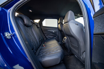 Row of passenger rear seats upholstered in black dry-cleaned fabric; pre-sale preparation