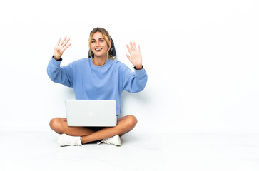 Young blonde Uruguayan girl with the laptop isolated on white background counting nine with fingers