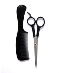 black hair comb and scissors for cutting hair on a white isolated background
