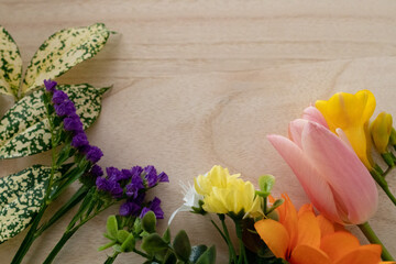 Colorful spring  flowers on wooden background