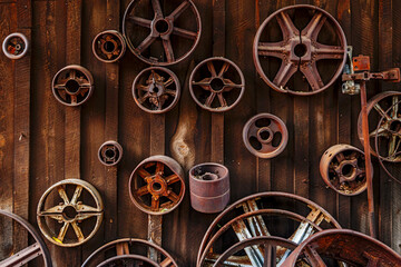 Obsolete rusty industrial parts on shed wall