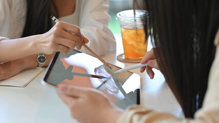 Businesswomen working their project and using mock up digital tablet