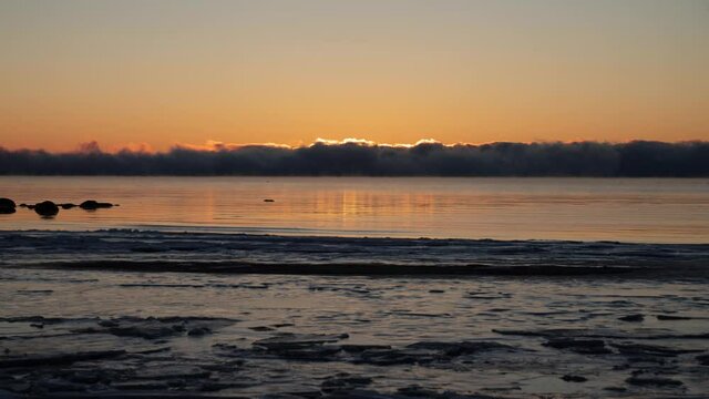 Sunrise time lapse over Oslofjord in  Tonsberg, Norway.  A lot of swans and seagulls show up as suns go up