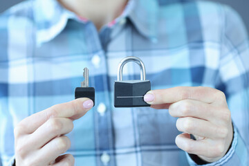 Human holds key and padlock on his hand