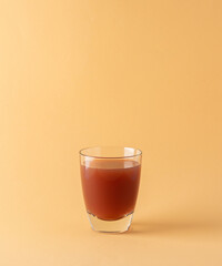 Delicious sweet mango and pomegranate juices in glass isolated on beige background