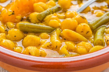 Pumpkin potaje. Traditional Spanish stew with chickpeas, beans, green beans, pumpkin and mint.