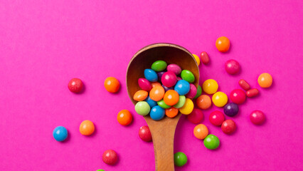 Obraz premium multicolored candy set with a wooden spoon