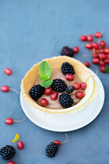 dessert with cream in a crispy waffle edible plate