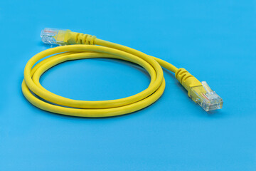 Yellow network cable with DOF connectors. On a blue background. Close-up.