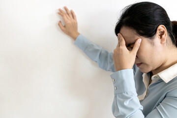 Asian woman suffering from dizziness,sensation of spinning around,losing her balance,Tired business...