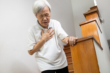 Asian senior grandmother suffering from pain in chest with acute dyspnea or asthma disease,Tired...