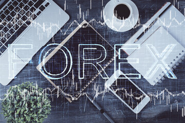Double exposure of forex chart hologram over desktop with phone. Top view. Mobile trade platform concept.
