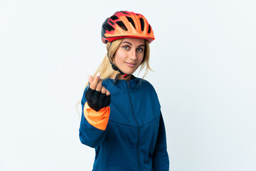 Young blonde Uruguayan cyclist woman isolated on background making money gesture