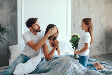 Young husband and his daughter surprising mom on special day