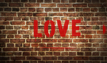 Obraz premium Love spray painted inscription on the brick wall
