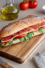 Sandwich with prosciutto, tomatoes, arugula and cheese. Healthy eating. Diet.