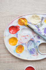 Artist's palette, top view. Mixing paints, brush. Texture, background