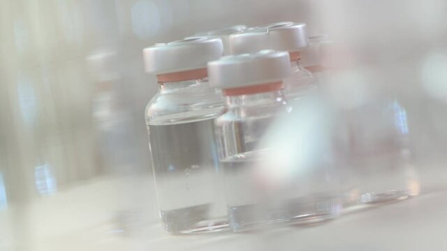 Vaccine glass bottle vials on laboratory desk