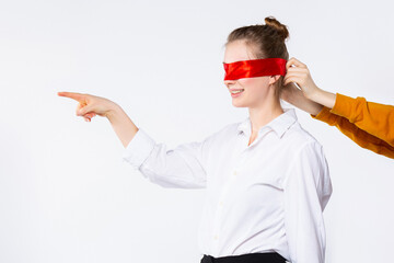 Photo of smiling blonde student, finished university, view future career job with closed eyes. Female pointing forefinger to empty side space, isolated white background