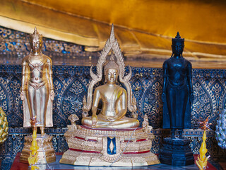 Small Buddha figures on a table in a temple in Bangkok