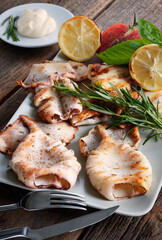 Squid grilled with rosemary sauce on the white plate.