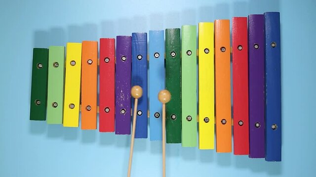 playing a colorful toy xylophone, top view