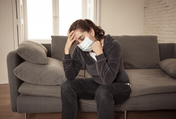 Lonely woman suffering from depression at home during coronavirus lockdown and social distancing