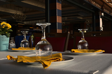 A ready table for drink with empty wine glasses.