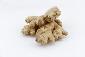 Fresh ginger on a white isolated background - close-up photo