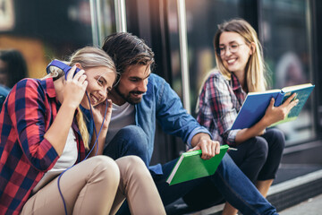 Education, campus, friendship and people concept. Group of happy students outdoor