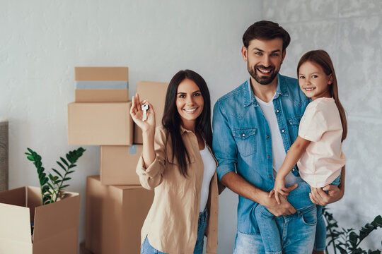 Lovely Family Of Three People Looking Happy In New Home