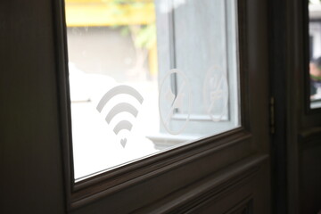 wifi sign on glass wooden door