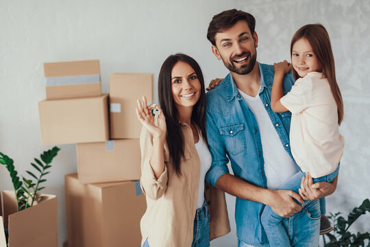 Happy Young Family Moving Into A New Home