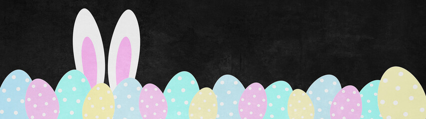 Easter background panorama banner greeting card - Many colorful pastel painted easter eggs and easter bunny ears isolated on black blackboard texture