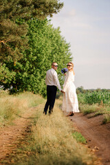 The bride and groom walk along the path